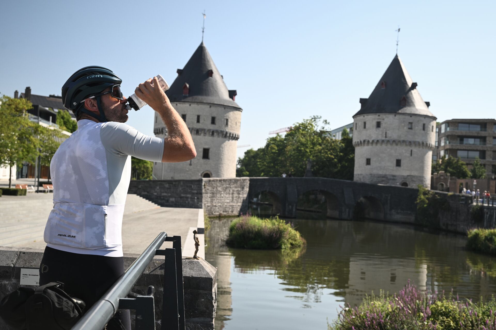 CYCLING IN FLANDERS Cyclist drinking from his bottle in Kortrijk near the Broeltorens