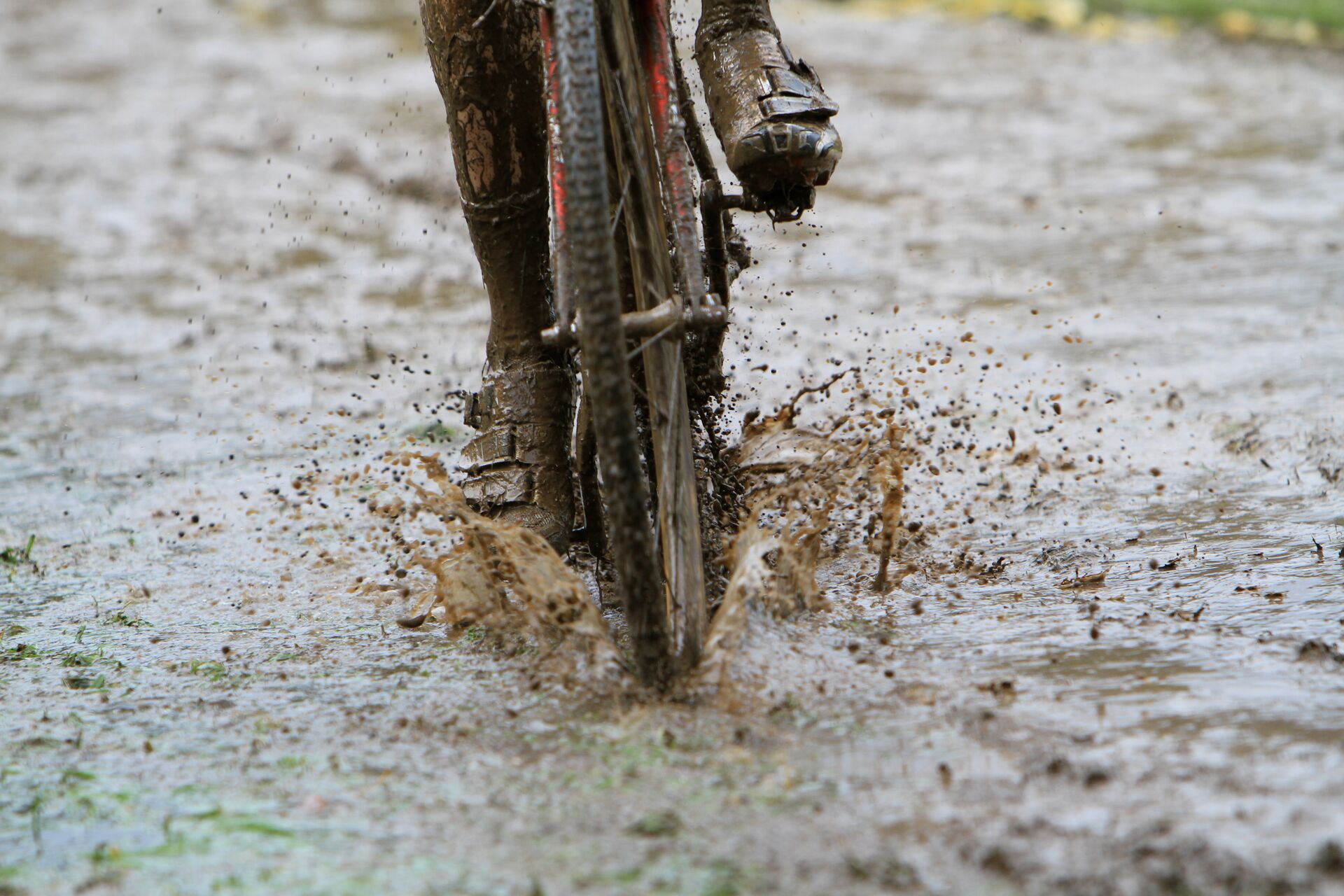 Front view of cyclist riding through puddle 